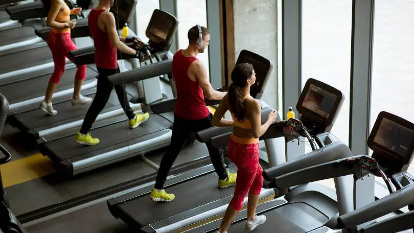 Couple Run on Treadmills in the Gym