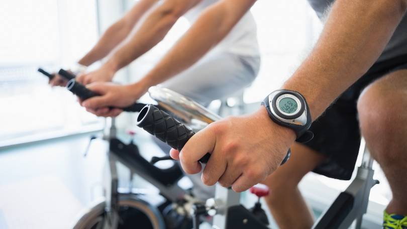 Men working on exercise bikes