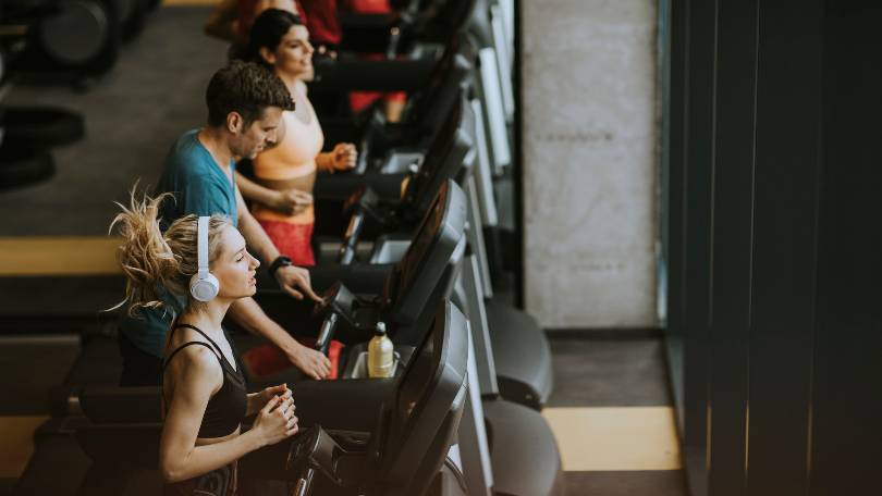 Young People Running on Treadmills in Modern Gym